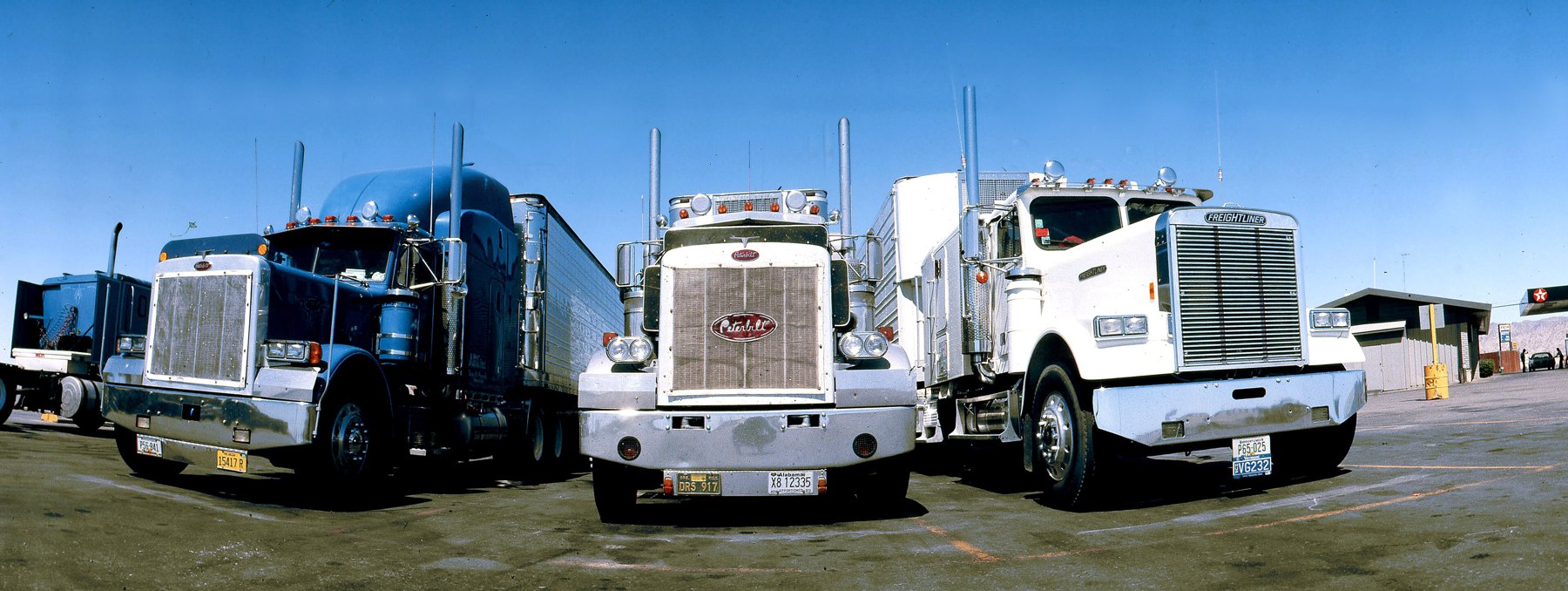 A row of tractor units parked in a lot